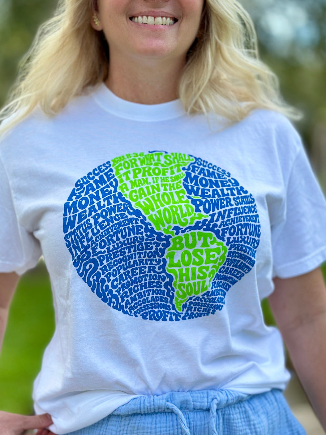 Woman wearing What Does It Profit Mark 8:36 Christian t-shirt on white Comfort Colors tee